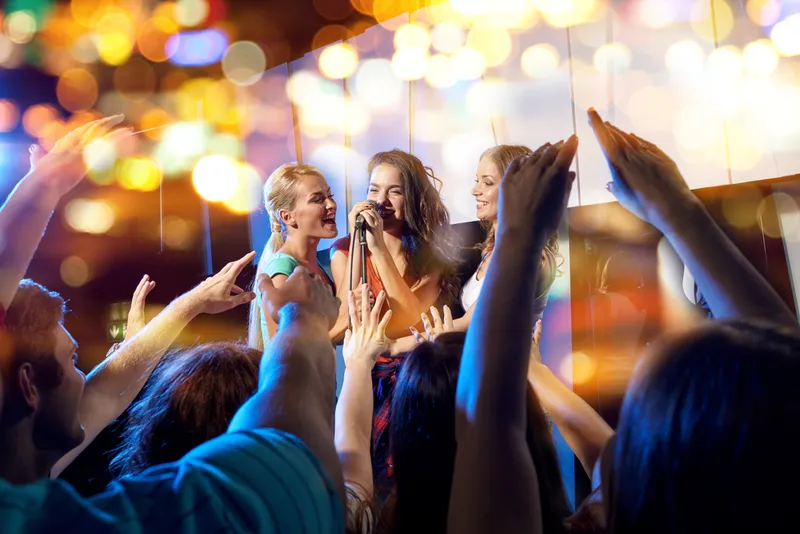 Karaoke performance with a cheering audience at a company party