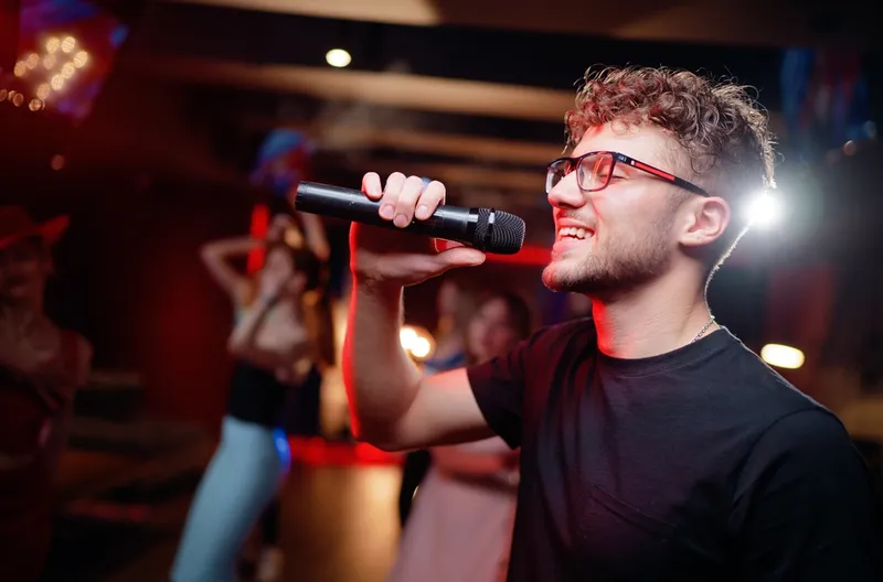 Young man singing karaoke at a birthday party