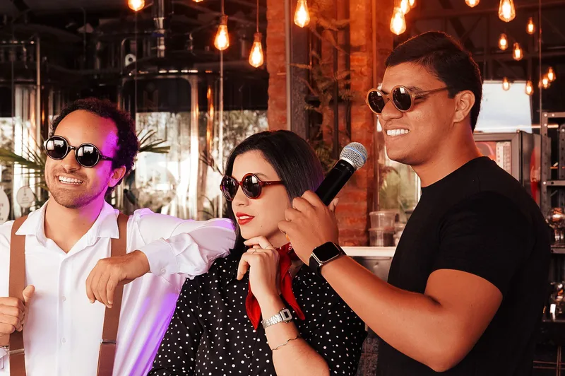Three colleagues singing karaoke together
