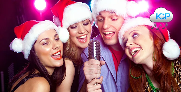 Colleagues singing karaoke together at a company Christmas party